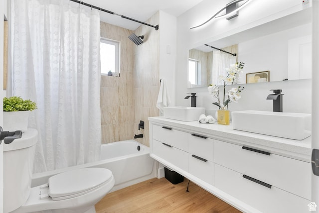1379 E Sumac Way, Murray, UT 84121 - bathroom featuring toilet, shower / bathtub combination with curtain, double vanity, and wood finished floors