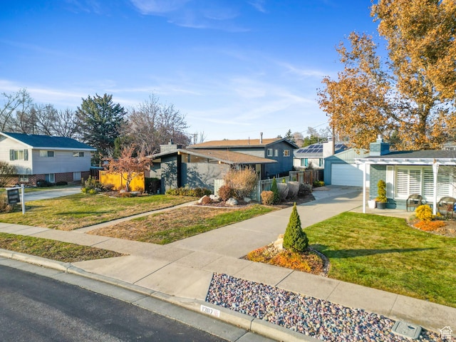 1379 E Sumac Way, Murray, UT 84121 - view of front of home with a residential view, a garage, and concrete driveway