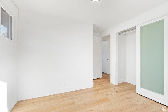 1379 E Sumac Way, Murray, UT 84121 - unfurnished bedroom with light wood-style flooring, baseboards, and a closet