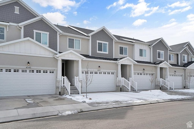 townhome / multi-family property featuring board and batten siding and a garage