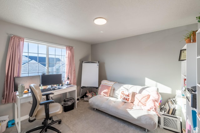 home office featuring carpet, a textured ceiling, and baseboards