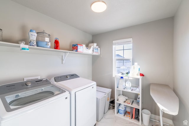 laundry area featuring laundry area, marble finish floor, and separate washer and dryer