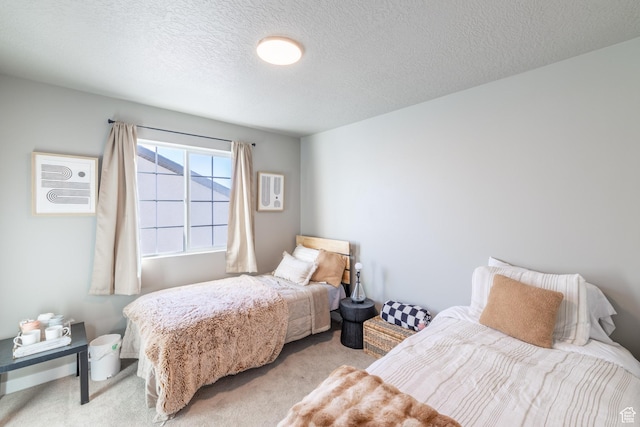 bedroom with light carpet and a textured ceiling