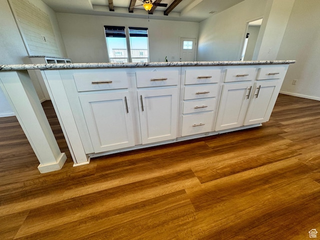 interior space featuring baseboards and wood finished floors
