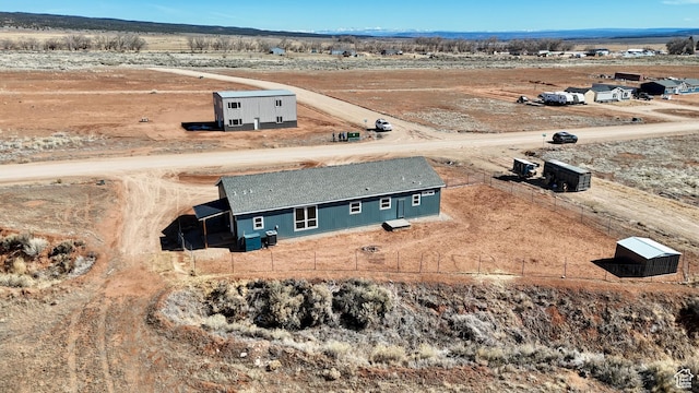 birds eye view of property featuring view of desert and a rural view