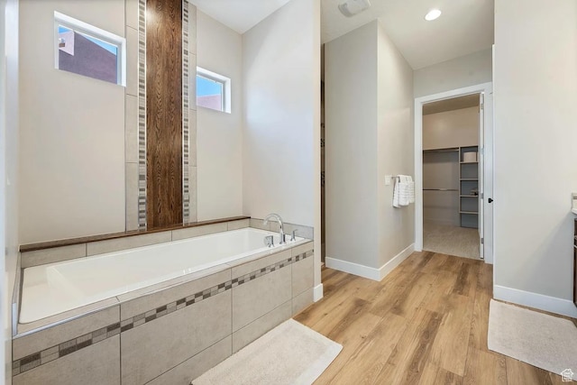 5417 W Copper Cliffs Way, Hurricane, UT 84737 - bathroom featuring a walk in closet, baseboards, wood finished floors, and a bath