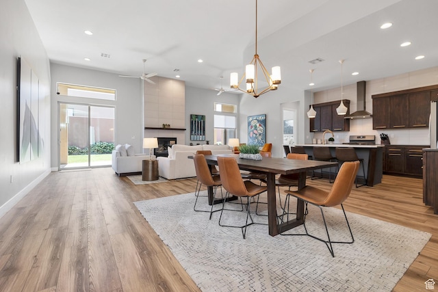 5417 W Copper Cliffs Way, Hurricane, UT 84737 - dining room featuring recessed lighting, light wood-style flooring, and a fireplace