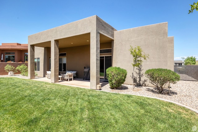5417 W Copper Cliffs Way, Hurricane, UT 84737 - back of property with stucco siding, fence, a patio area, and a yard