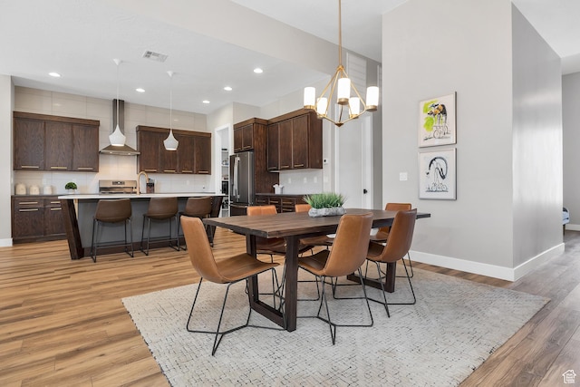 5417 W Copper Cliffs Way, Hurricane, UT 84737 - dining area with recessed lighting, an inviting chandelier, light wood-type flooring, baseboards, and visible vents