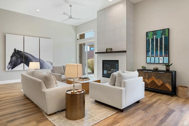 5417 W Copper Cliffs Way, Hurricane, UT 84737 - living area featuring recessed lighting, a high ceiling, a tiled fireplace, a ceiling fan, and light wood-style flooring