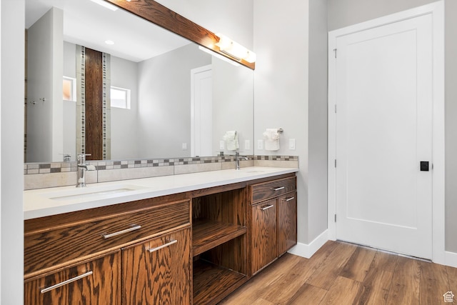 5417 W Copper Cliffs Way, Hurricane, UT 84737 - full bathroom featuring a sink, baseboards, wood finished floors, and tasteful backsplash