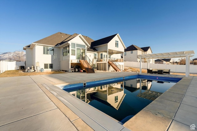 view of swimming pool featuring a fenced in pool, a patio, stairway, a pergola, and a fenced backyard