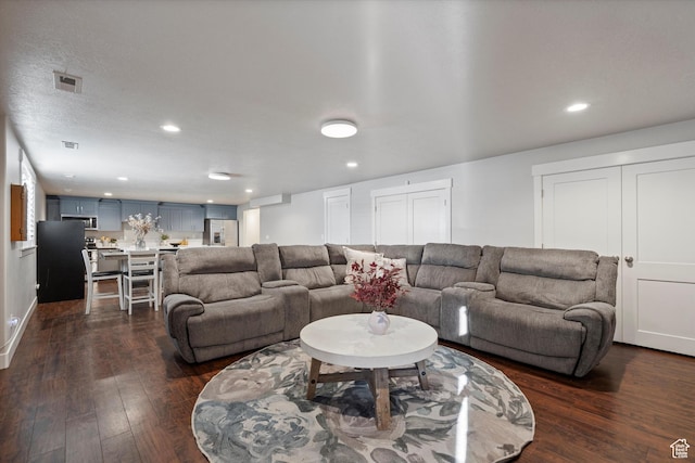 living area with dark wood-type flooring, recessed lighting, and visible vents