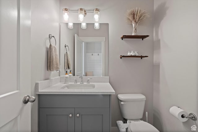 bathroom featuring vanity and toilet