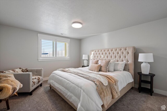carpeted bedroom featuring a textured ceiling, visible vents, and baseboards