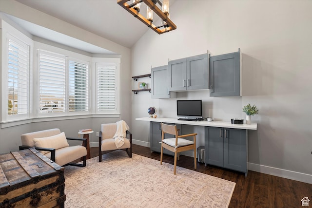 office area with lofted ceiling, dark wood-style flooring, built in study area, and baseboards