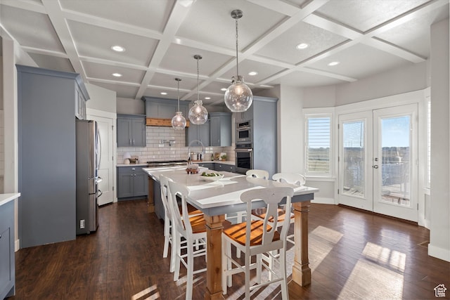 dining room with recessed lighting, coffered ceiling, baseboards, french doors, and dark wood finished floors