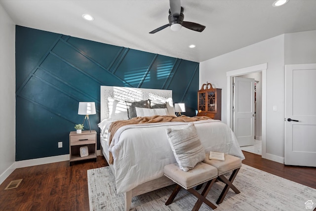 bedroom with baseboards, visible vents, wood finished floors, and recessed lighting