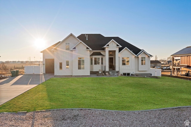 modern farmhouse with a front lawn and fence