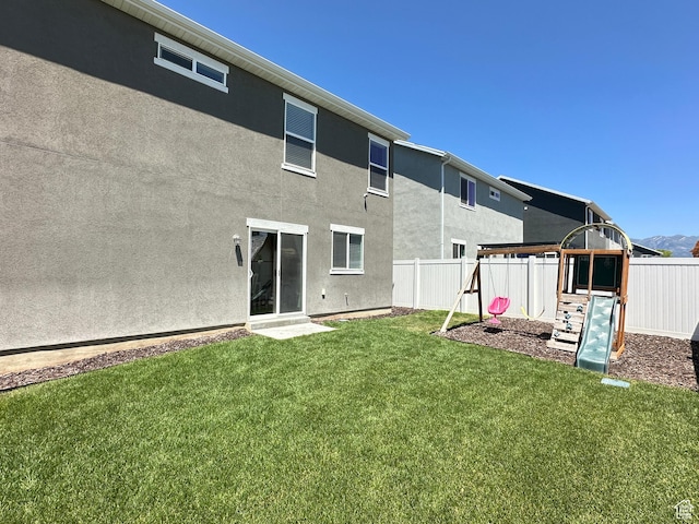 2095 W 3330 S, Syracuse, UT 84075 - rear view of house featuring a playground and stucco siding
