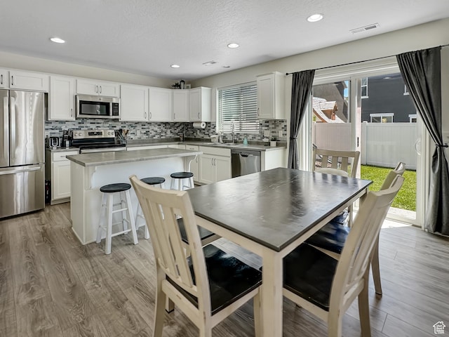 2095 W 3330 S, Syracuse, UT 84075 - dining space featuring light wood-style floors, recessed lighting, and a textured ceiling