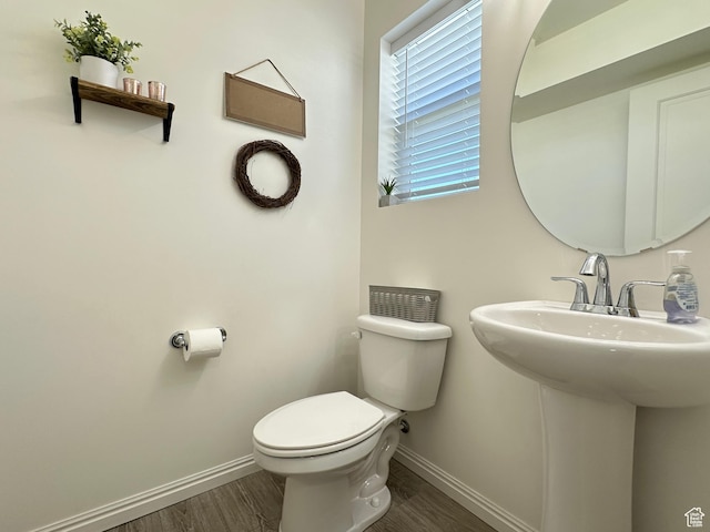 2095 W 3330 S, Syracuse, UT 84075 - half bath with baseboards, wood finished floors, toilet, and a sink