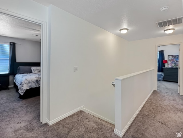 2095 W 3330 S, Syracuse, UT 84075 - hallway featuring carpet floors, an upstairs landing, a textured ceiling, and baseboards