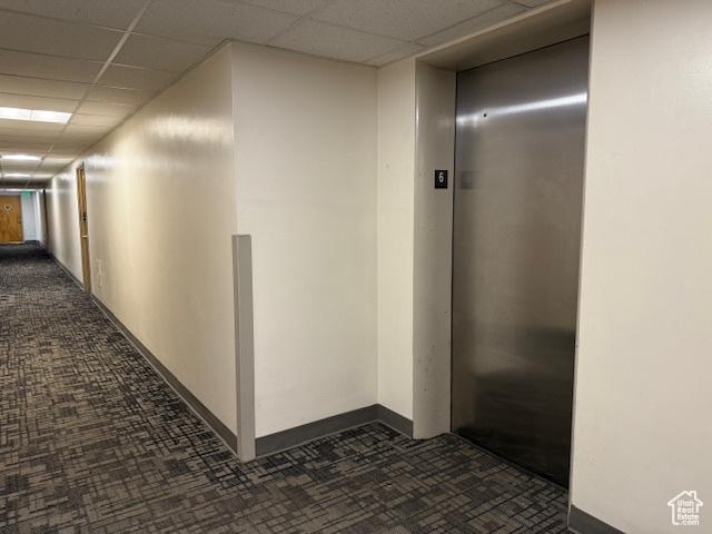130 S 1300 E Unit 602, Salt Lake City, UT 84102 - corridor with elevator, dark colored carpet, and a drop ceiling