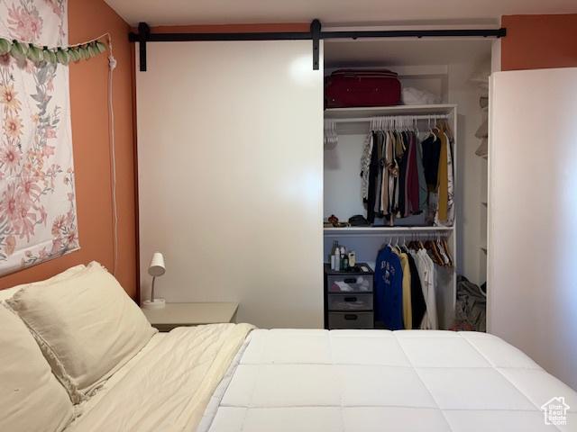130 S 1300 E Unit 602, Salt Lake City, UT 84102 - bedroom featuring a barn door and a closet