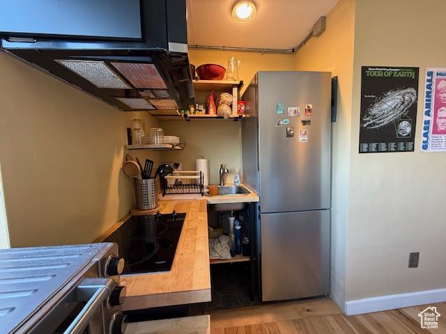 130 S 1300 E Unit 602, Salt Lake City, UT 84102 - kitchen featuring freestanding refrigerator, open shelves, black electric cooktop, and light wood finished floors