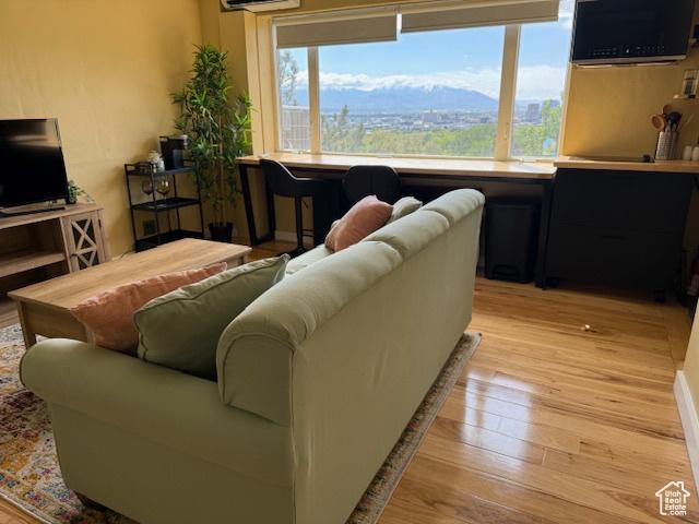 130 S 1300 E Unit 602, Salt Lake City, UT 84102 - living room with healthy amount of natural light, light wood-style floors, and an AC wall unit