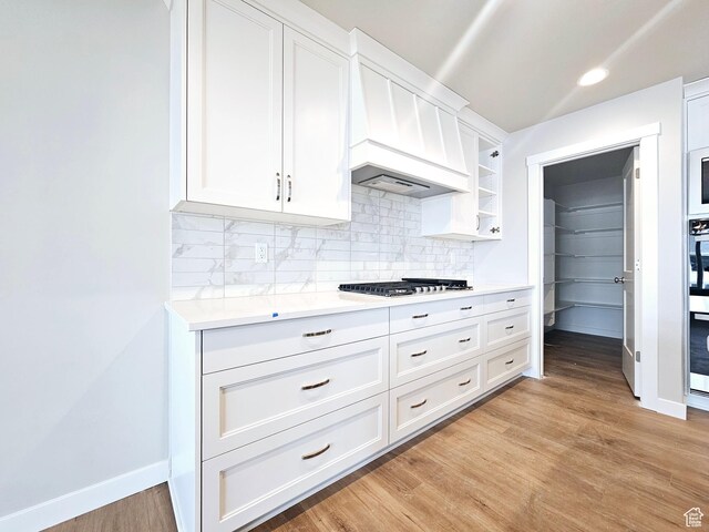 3102 N 2875 W Unit 27, Plain City, UT 84404 - kitchen featuring light wood finished floors, light countertops, backsplash, appliances with stainless steel finishes, and white cabinetry