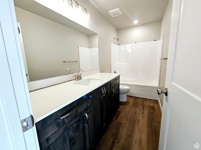 3102 N 2875 W Unit 27, Plain City, UT 84404 - full bathroom featuring visible vents, toilet, wood finished floors, vanity, and shower / bathing tub combination