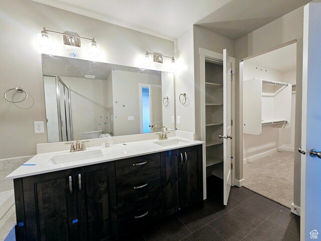 3102 N 2875 W Unit 27, Plain City, UT 84404 - bathroom featuring double vanity, a stall shower, a sink, and tile patterned floors