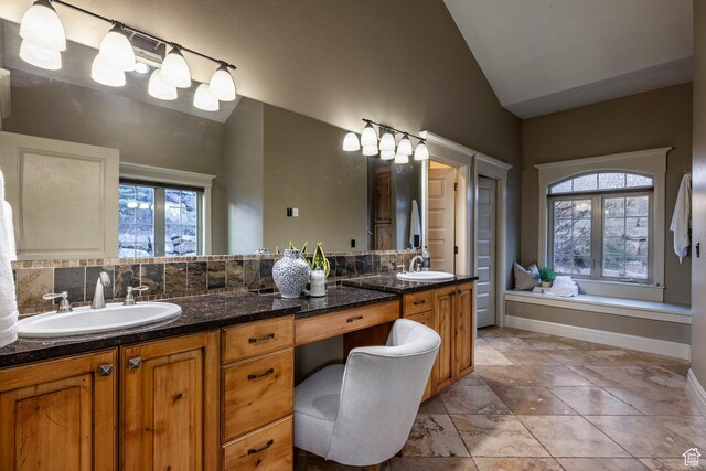 14794 S Vintage View Ln, Draper, UT 84020 - full bath with vaulted ceiling, double vanity, a sink, and baseboards