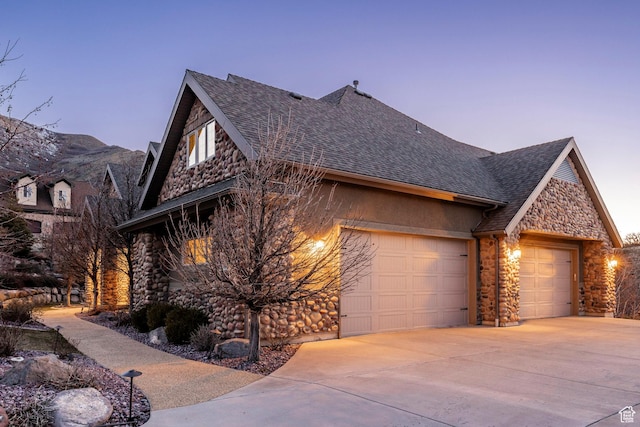 14794 S Vintage View Ln, Draper, UT 84020 - view of front of home with a garage, stone siding, a shingled roof, and concrete driveway