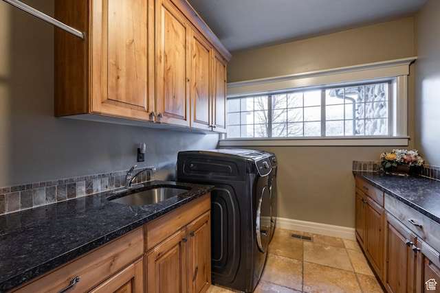 14794 S Vintage View Ln, Draper, UT 84020 - laundry room featuring stone tile floors, a sink, baseboards, washer and dryer, and cabinet space