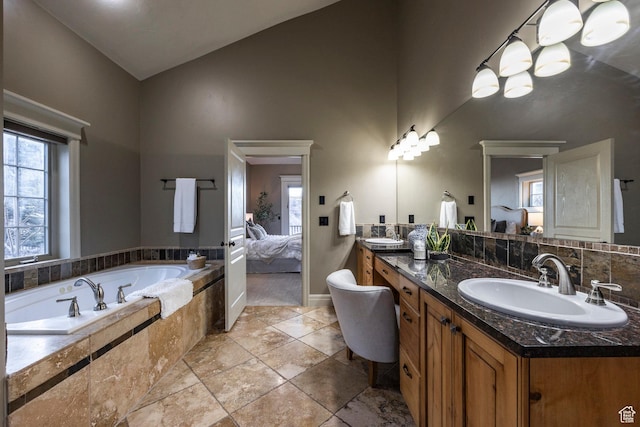 14794 S Vintage View Ln, Draper, UT 84020 - bathroom featuring high vaulted ceiling, a garden tub, a sink, double vanity, and ensuite bath
