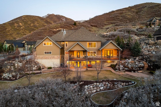 14794 S Vintage View Ln, Draper, UT 84020 - back of house with stone siding, a patio area, a mountain view, and stucco siding