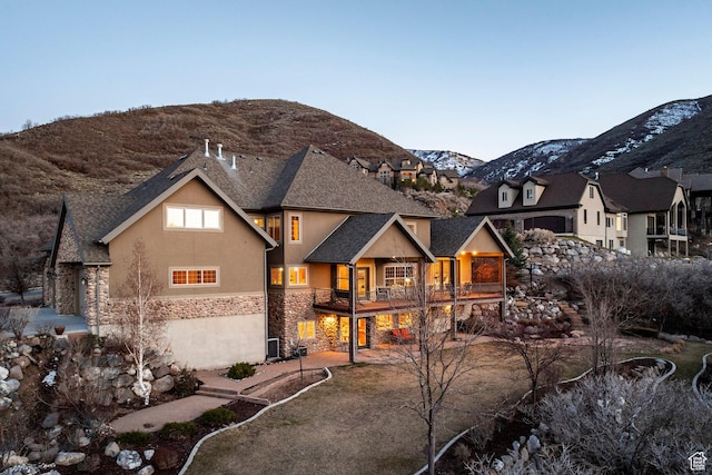 14794 S Vintage View Ln, Draper, UT 84020 - view of front facade featuring a shingled roof, stone siding, a mountain view, central AC, and stucco siding