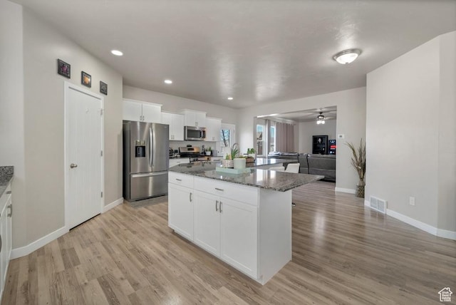 721 S Jubilee Dr, Saratoga Springs, UT 84045 - kitchen featuring a center island, visible vents, appliances with stainless steel finishes, open floor plan, and light wood-type flooring