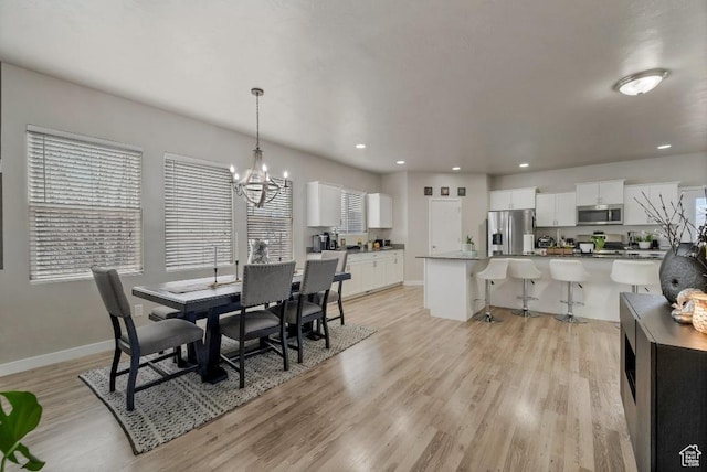 721 S Jubilee Dr, Saratoga Springs, UT 84045 - dining room with light wood finished floors, baseboards, a chandelier, and recessed lighting