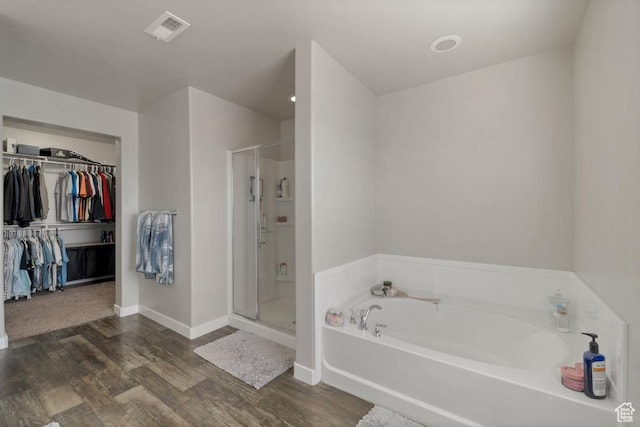 721 S Jubilee Dr, Saratoga Springs, UT 84045 - full bathroom with a bath, a stall shower, visible vents, and wood finished floors