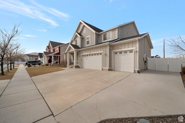 721 S Jubilee Dr, Saratoga Springs, UT 84045 - view of side of home featuring an attached garage, fence, driveway, a residential view, and board and batten siding