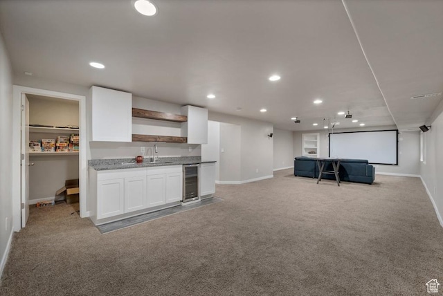 721 S Jubilee Dr, Saratoga Springs, UT 84045 - kitchen with open shelves, open floor plan, white cabinets, light carpet, and beverage cooler