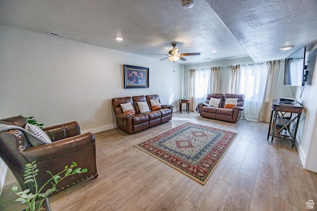 7912 N Secretariat Rd, Eagle Mountain, UT 84005 - living room featuring a ceiling fan, wood finished floors, visible vents, baseboards, and a textured ceiling
