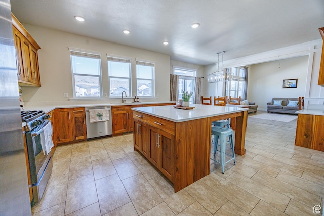 7912 N Secretariat Rd, Eagle Mountain, UT 84005 - kitchen featuring brown cabinetry, appliances with stainless steel finishes, and a breakfast bar area