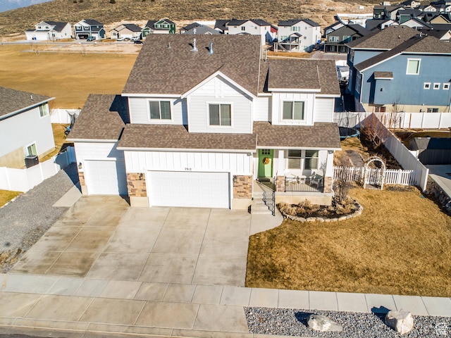 7912 N Secretariat Rd, Eagle Mountain, UT 84005 - view of front of house featuring fence, a residential view, a shingled roof, concrete driveway, and board and batten siding