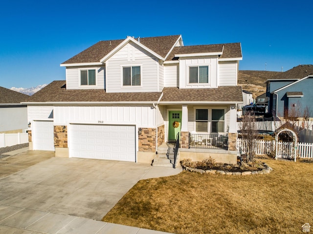 7912 N Secretariat Rd, Eagle Mountain, UT 84005 - view of front of home featuring fence, driveway, covered porch, a shingled roof, and board and batten siding
