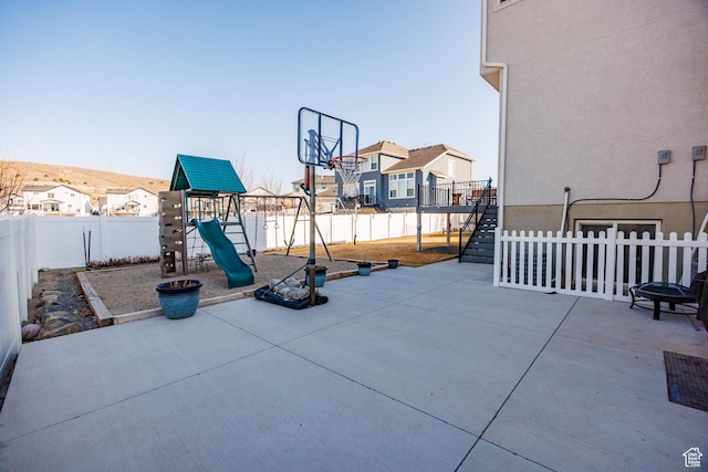 7912 N Secretariat Rd, Eagle Mountain, UT 84005 - view of patio / terrace with a fenced backyard and a playground